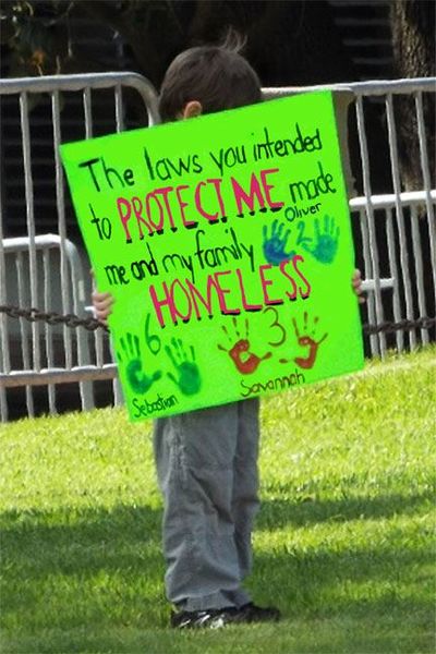 File:Child protesting against hardship caused by strict sex offender policies.jpg