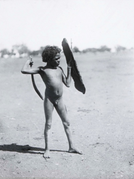 File:BASEDOW Herbert 1922c Arrernte boy practising with toy shield and boomerang, Alberga River, South Australia 1140x1525.jpg