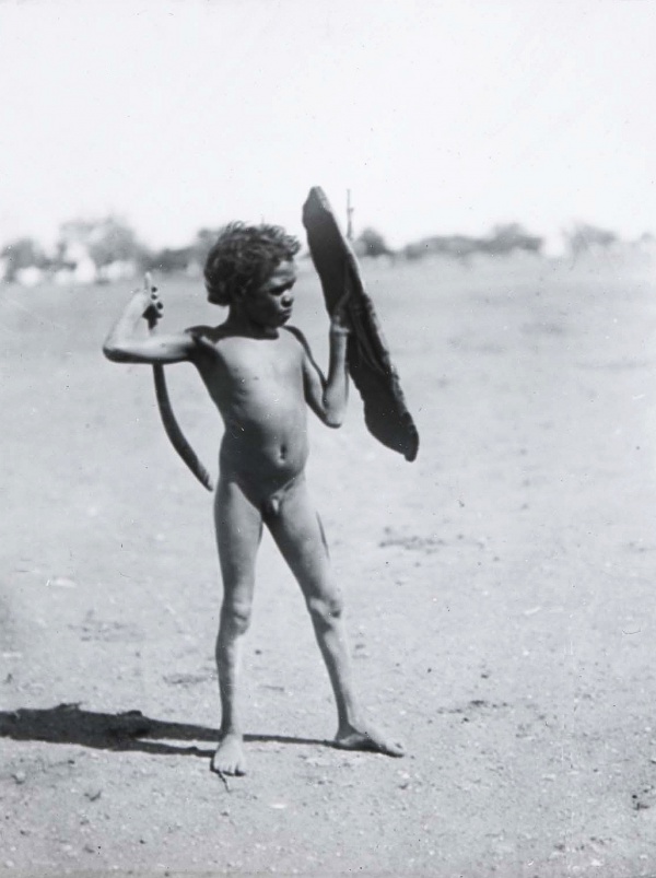 BASEDOW Herbert 1922c Arrernte boy practising with toy shield and boomerang, Alberga River, South Australia 1140x1525.jpg